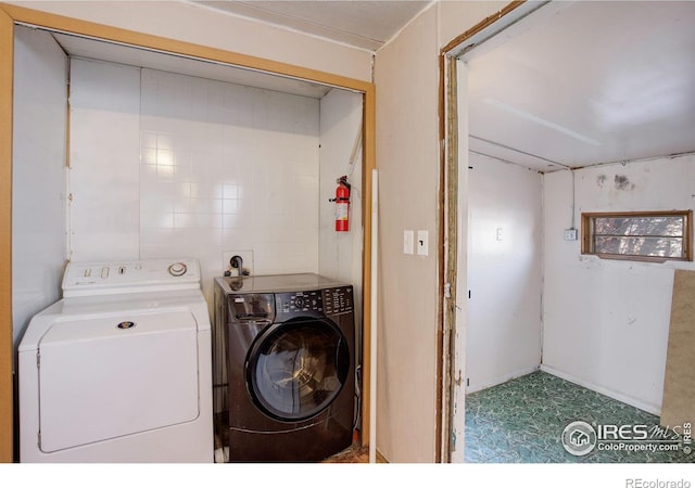 clothes washing area featuring washer and dryer