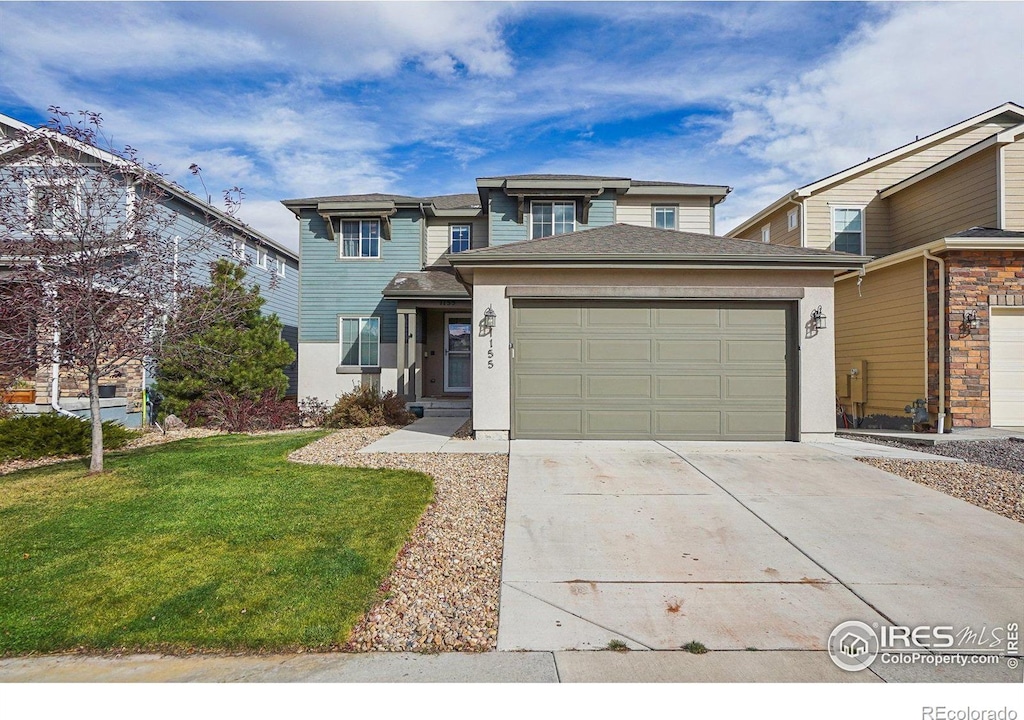 view of front of property featuring a garage and a front yard