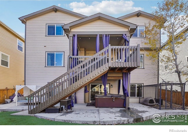 back of house featuring a patio and a hot tub