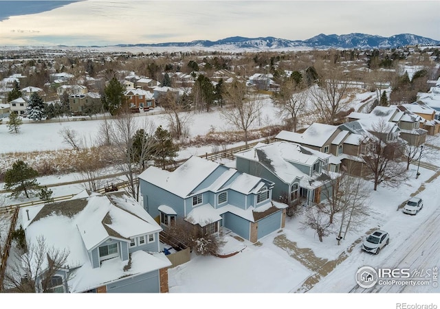 snowy aerial view featuring a mountain view