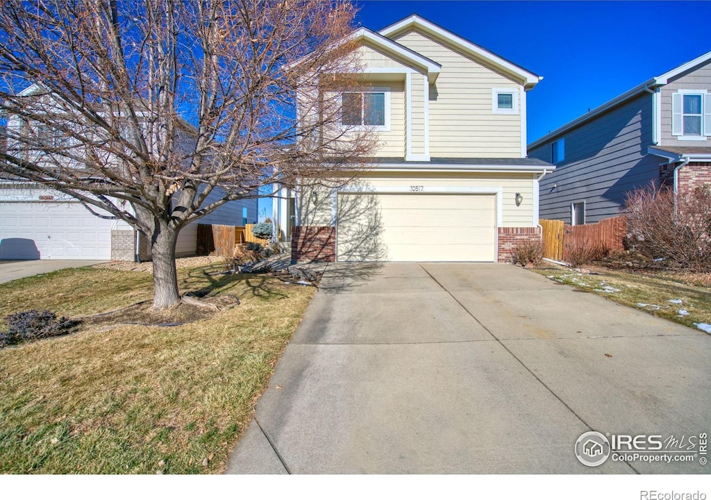 view of front property featuring a front yard and a garage