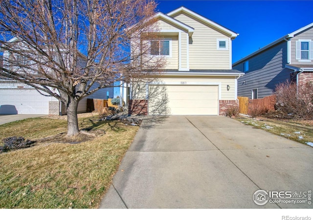 view of front property featuring a front yard and a garage