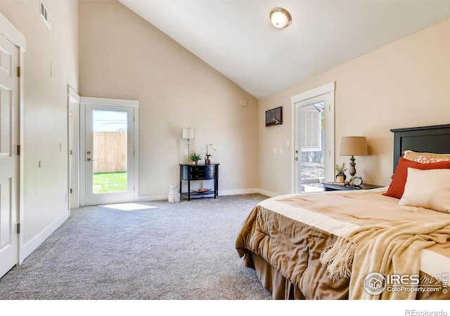 carpeted bedroom with access to exterior and high vaulted ceiling