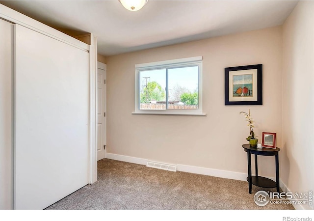 unfurnished bedroom featuring light colored carpet