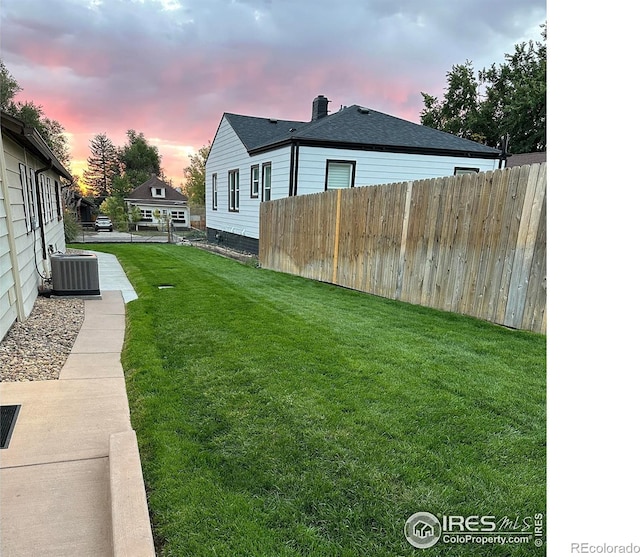 yard at dusk with central AC