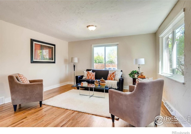 living room with hardwood / wood-style flooring and a textured ceiling