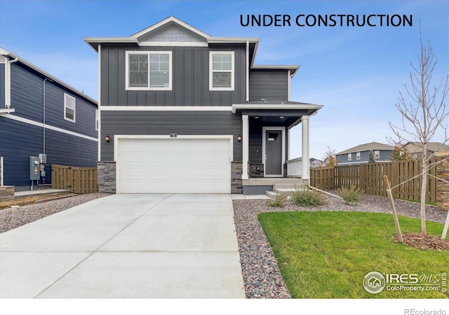 view of front of property featuring a front yard and a garage