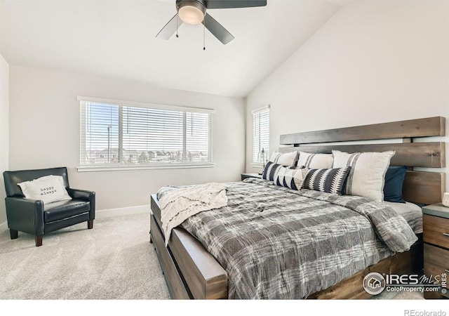 carpeted bedroom with multiple windows, ceiling fan, and lofted ceiling