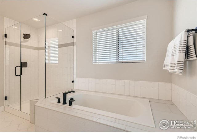 bathroom featuring shower with separate bathtub