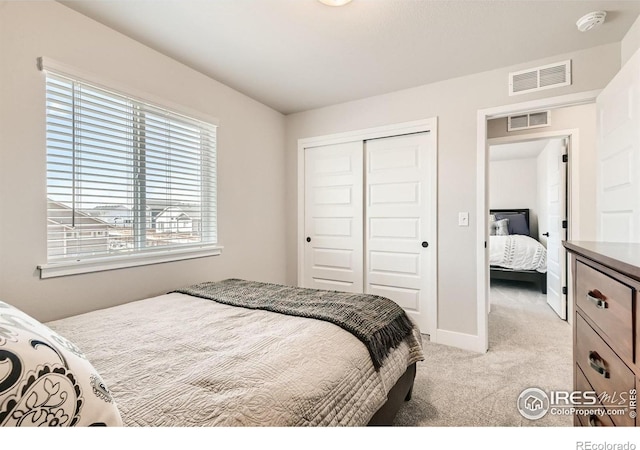 carpeted bedroom with a closet