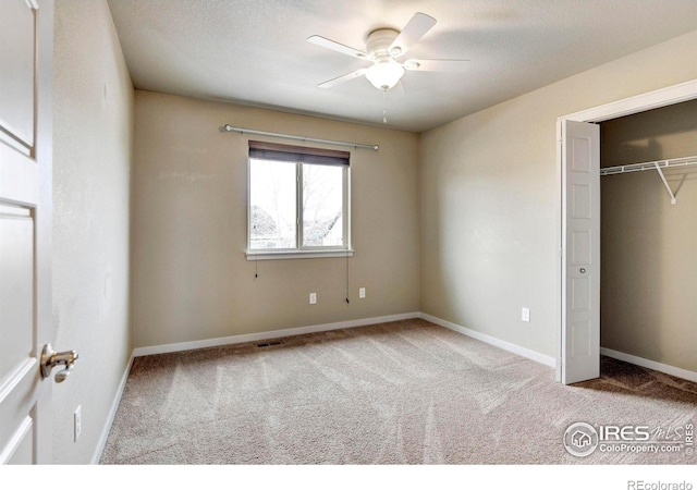 unfurnished bedroom with light carpet, a closet, visible vents, and baseboards