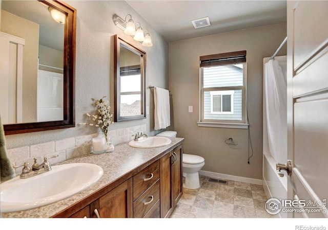 bathroom featuring double vanity, a sink, and visible vents