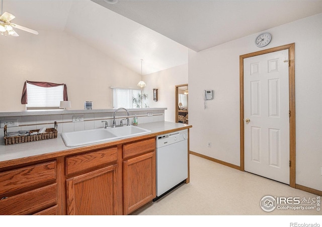 kitchen featuring tasteful backsplash, lofted ceiling, sink, hanging light fixtures, and white dishwasher