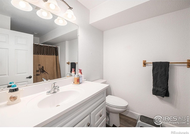 bathroom featuring vanity, toilet, and hardwood / wood-style floors