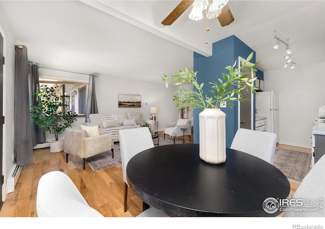 dining room with ceiling fan, a baseboard radiator, lofted ceiling, and light wood-type flooring