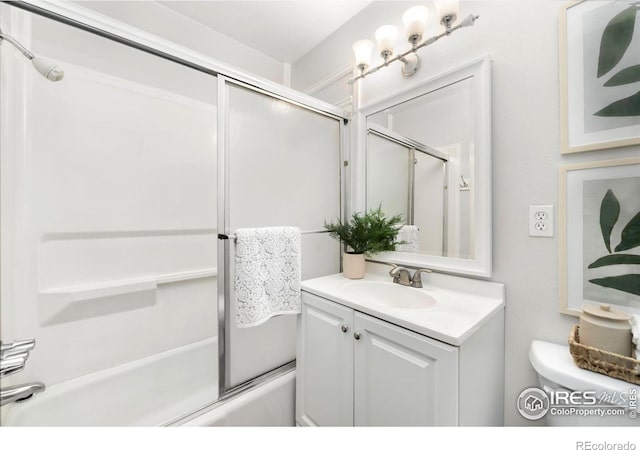 full bathroom featuring shower / bath combination with glass door, vanity, and toilet