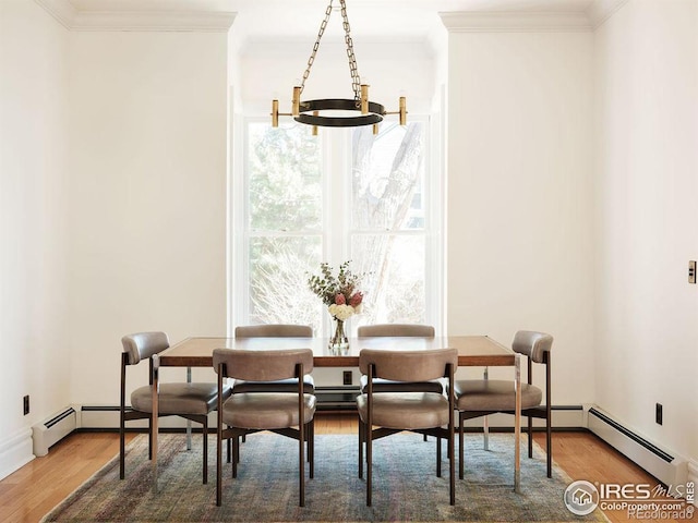 dining room with wood-type flooring, crown molding, and a notable chandelier