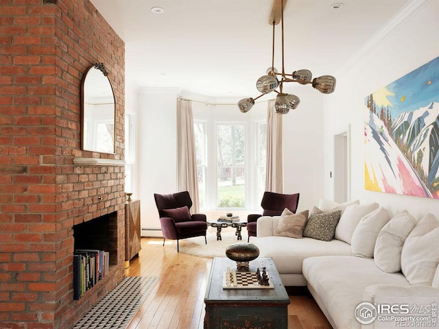 living room with hardwood / wood-style floors, a baseboard radiator, a brick fireplace, and crown molding