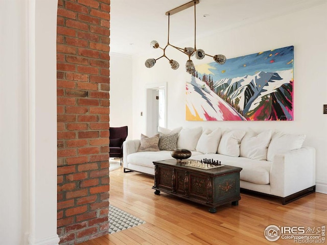 living room with hardwood / wood-style flooring and crown molding