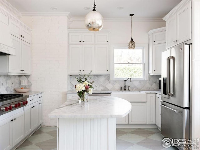 kitchen with white cabinetry, a center island, light stone countertops, and appliances with stainless steel finishes