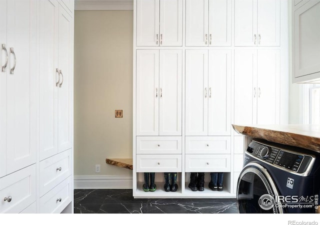 washroom with cabinets and washer / clothes dryer