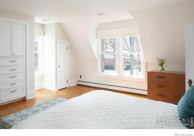 bedroom featuring light hardwood / wood-style floors, vaulted ceiling, multiple windows, and a baseboard radiator