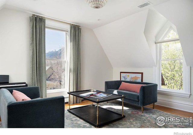 sitting room featuring hardwood / wood-style flooring and lofted ceiling