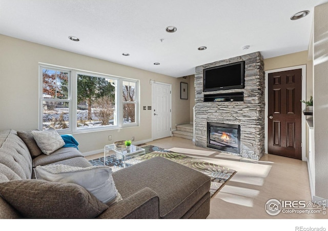 living room featuring a stone fireplace