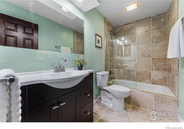 full bathroom with tiled shower / bath combo, vanity, and toilet