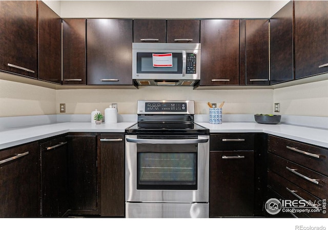 kitchen featuring dark brown cabinetry and appliances with stainless steel finishes