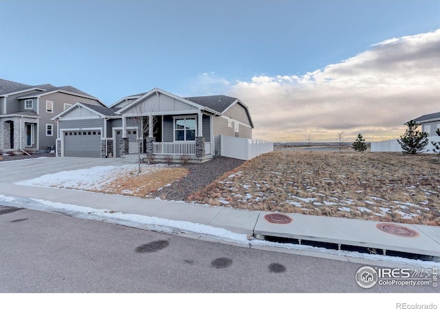 view of front of property with a porch and a garage