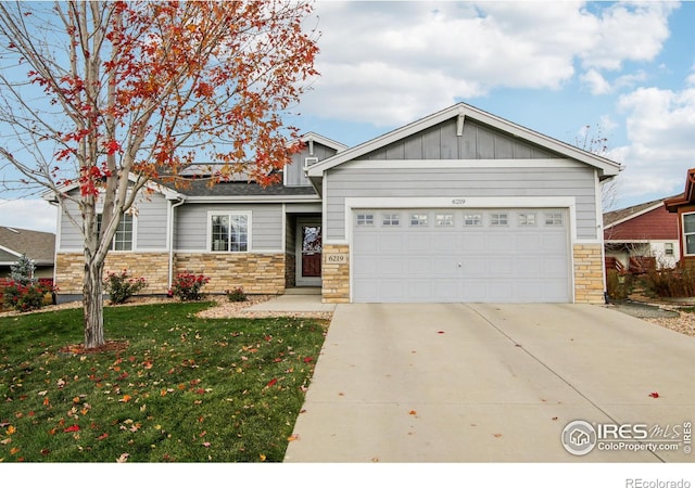 view of front of property with a garage and a front lawn