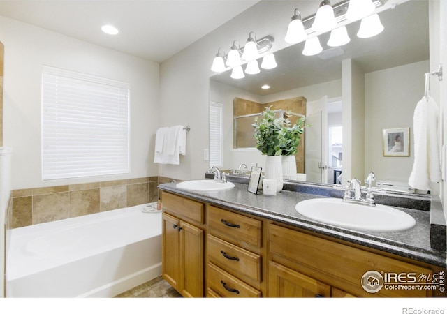 bathroom with plus walk in shower and vanity