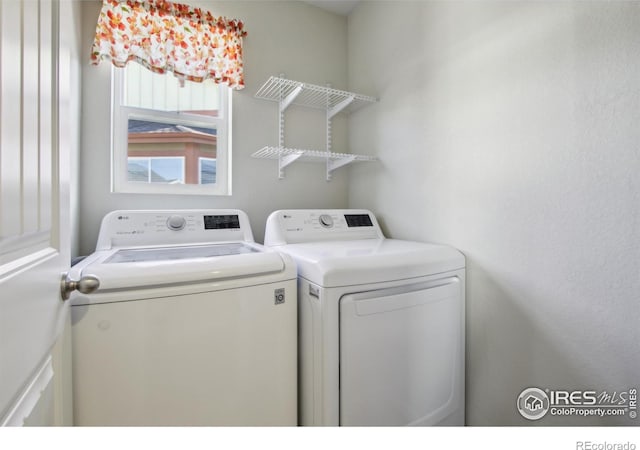 washroom featuring washing machine and dryer