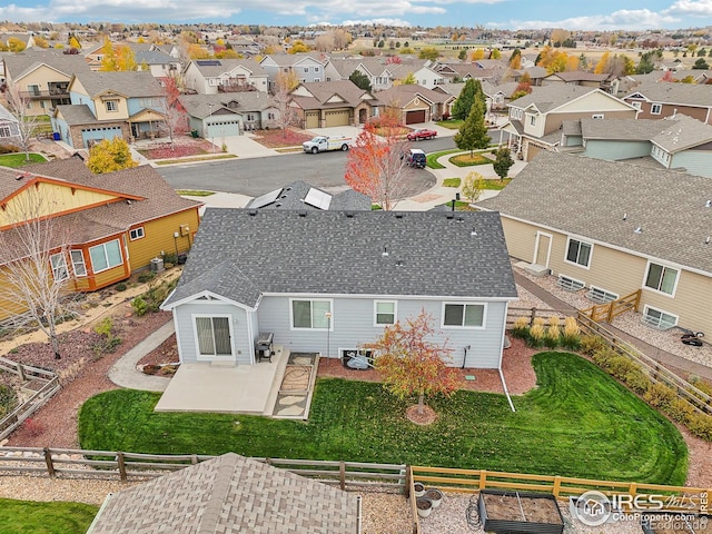 back of property featuring a lawn and a patio