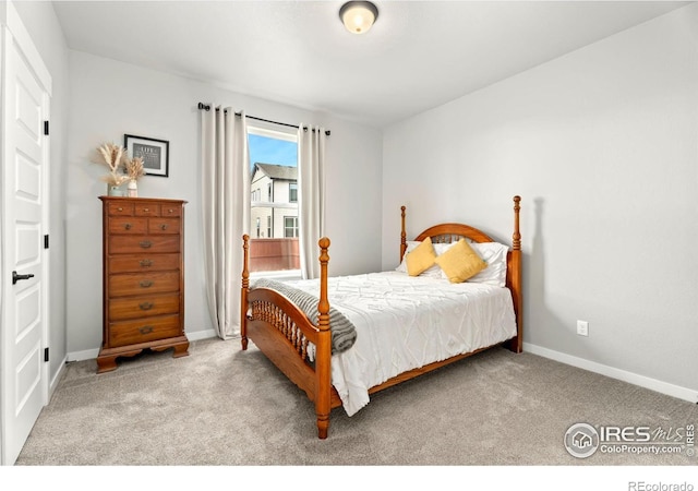 bedroom with light colored carpet