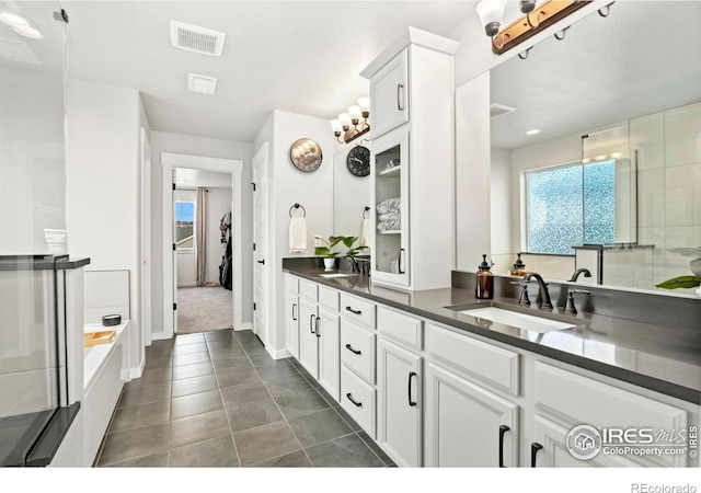 bathroom featuring tile patterned floors, walk in shower, and vanity