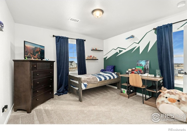 bedroom featuring light colored carpet