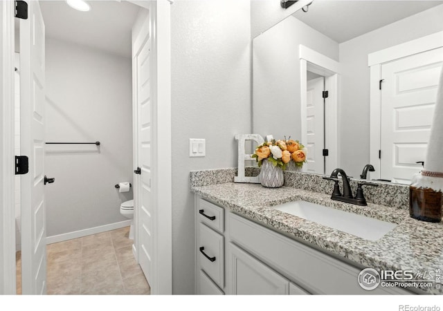 bathroom with vanity, tile patterned floors, and toilet