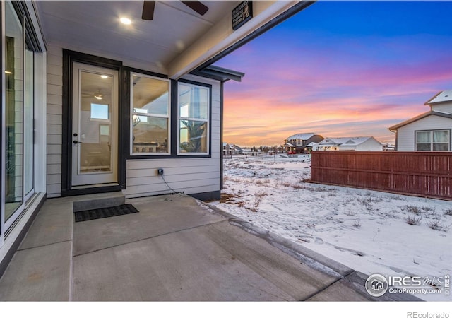 snow covered property entrance with a patio area and ceiling fan