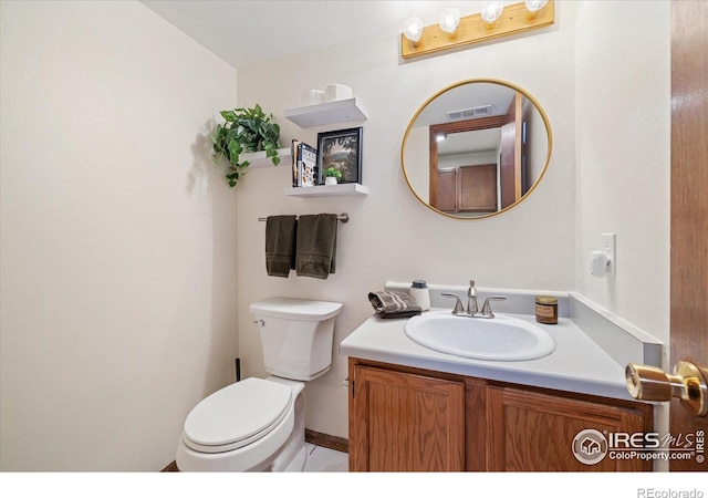 bathroom with toilet and vanity