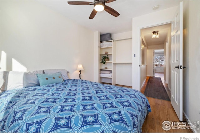 bedroom featuring ceiling fan and hardwood / wood-style flooring