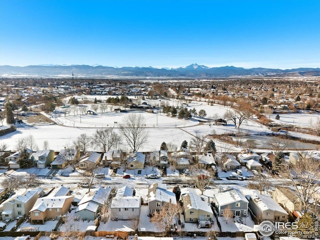 snowy aerial view featuring a mountain view