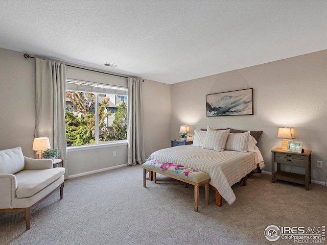 bedroom featuring a textured ceiling and carpet