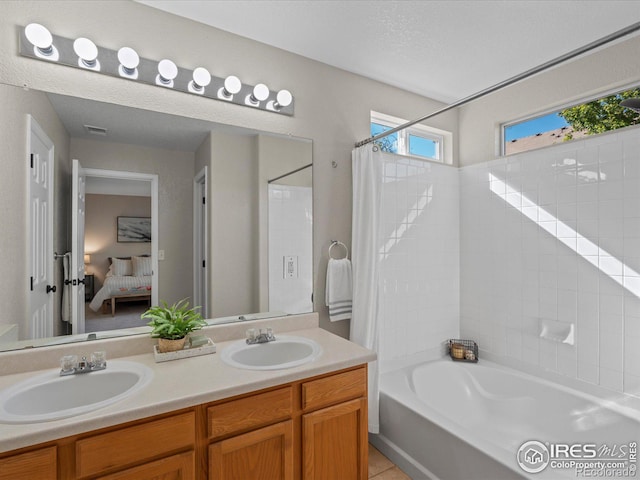 bathroom with shower / tub combo and vanity