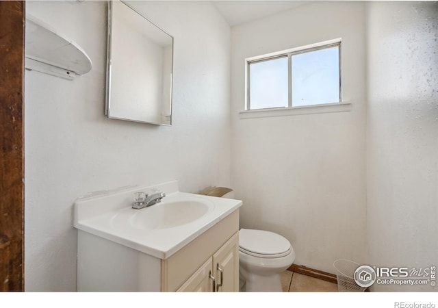 bathroom with tile patterned floors, vanity, and toilet