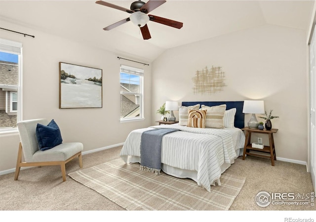 bedroom with ceiling fan, vaulted ceiling, and carpet