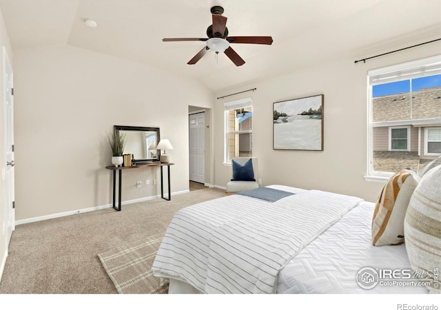 bedroom featuring ceiling fan, vaulted ceiling, and light colored carpet