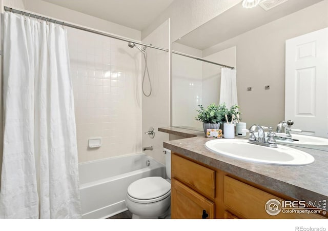 full bathroom with shower / bathtub combination with curtain, vanity, and toilet