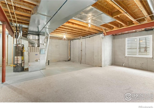 basement featuring gas water heater and heating unit